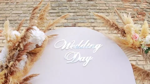 Horizontal shot of a decorative arch with Wedding Day text, pampas grass, a.. Stock-Footage 346221408