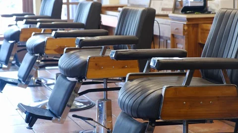 Horizontal shot of empty chairs in retro styled barbershop. Hair salon interior. Stock Footage 129672372