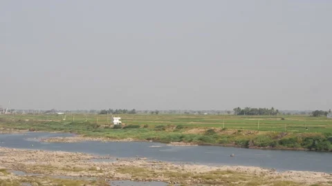 Horizontal shot of greenery at the banks of small water canals 動画素材 150719084