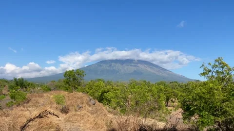 Horizontal Shot of Mount Agung with Ring Cloud Under Blue Sky 動画素材 341552216