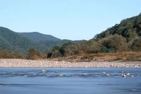Horizontal shot of the river in the valley on the background of mountains and Stock Photos