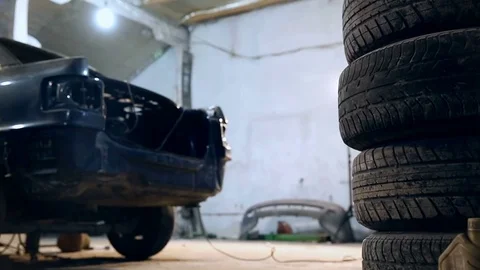 Horizontal slide shot of a stack of tires in a service station garage 動画素材 76227149
