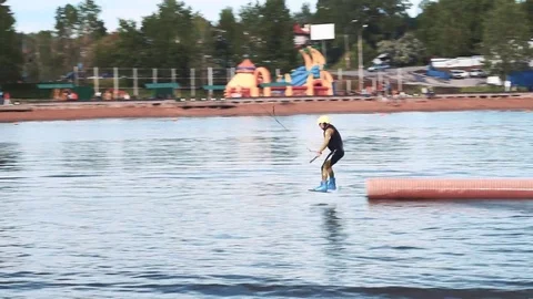 Horizontal slip on the pipe on the wakeboard. Tricks on the water Stock Footage 76836061