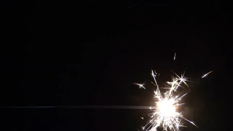 Horizontal Sparkler on black background Stock Footage 143612980