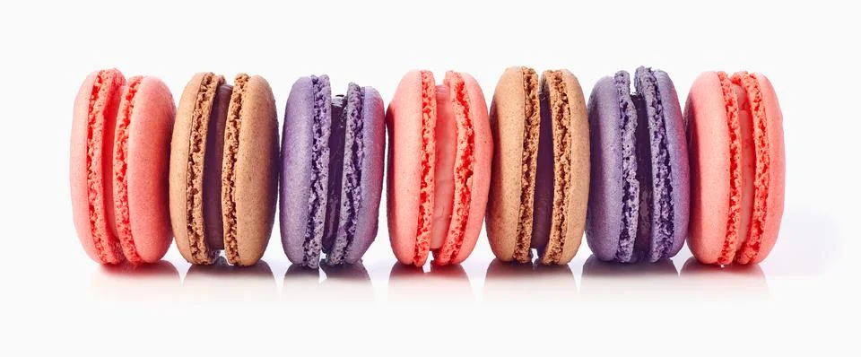 Horizontal stack of colorful macaroons on white background Stock Photos