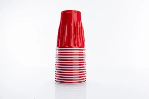 Horizontal stack of disposable red plastic cups isolated on a white background 库存照片
