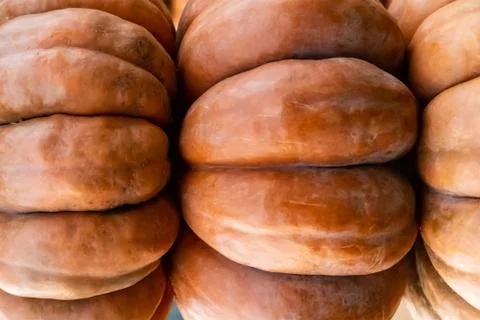 Horizontal stack large pumpkin orange ribbed close-up three vegetables design 스톡 사진