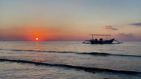 Horizontal Static Shot of Boat on Calm Sea at Sunset in Bali Stock Footage 339276633