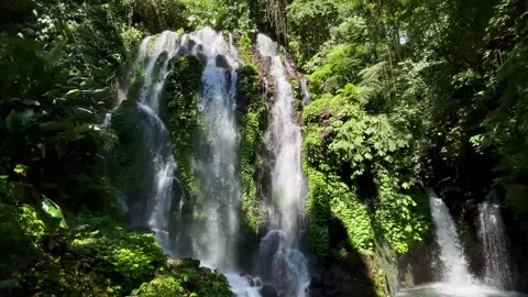 Horizontal Static Shot of Tropical Curtain Waterfall with a Person in Bali Stock Footage 339450344