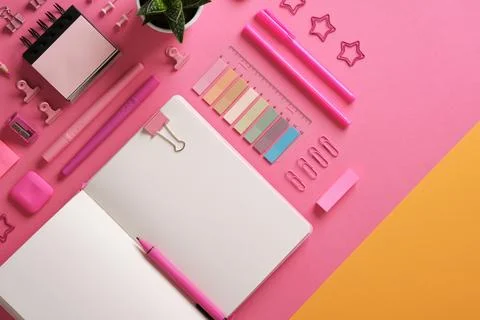 Horizontal stationery background with open notebook with stationery in pink t Stock Photos