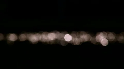 Horizontal stream of sun specks on dark background. Water reflection of the sun. Video stock 40806445