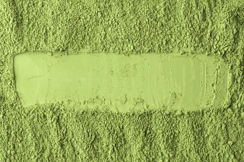 Horizontal stripe is drawn through vibrant matcha powder, dividing fine and Stock Photos