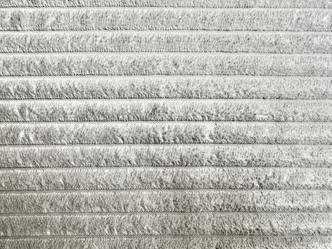 Horizontal striped pattern of light gray corduroy fabric texture close up sho Stock-Fotos