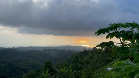 Horizontal Sunset View Over Distant Coast and Green Jungle in Bali Vidéo 341808814