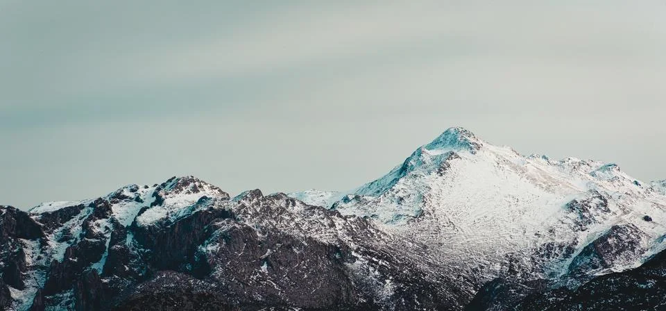 Horizontal super close up of a mountain range with snow in the peak Stock Photos