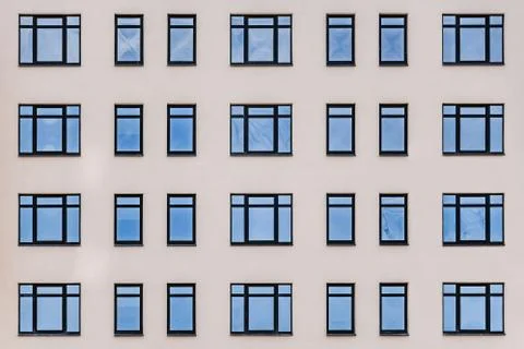 Horizontal texture of blue windows on a yellow wall Stock Photos