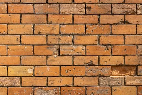 A horizontal texture of part of a new brick wall in brown hue is on the photo Stock Photos