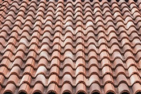 A horizontal texture of part of an old brown roof of clay tiles Stock Photos