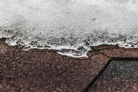 A horizontal texture of snowdrift of white snow with ice and bokeh light on a Stock Photos