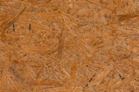 A horizontal texture of yellow chipboard for construction with knots Stock Photos