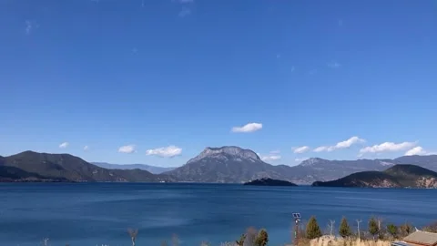 Horizontal Time-lapse of White Clouds Moving Over Gemu Goddess Mountain and Vídeos de archivo 326284103