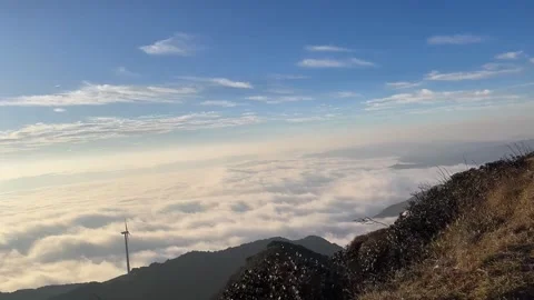 Horizontal Time-Lapse Wind Turbines Above Rolling Sea of Clouds at Mountain Video stock 328200281