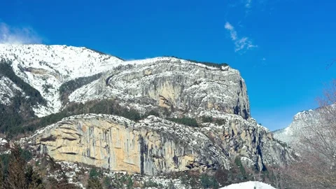 Horizontal Timelapse of a snowy mountain in the Pyrenees on a sunny and windy Video stock 203851019