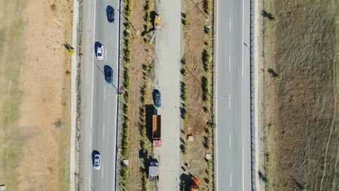 Horizontal top down aerial view of a multi lane highway with driving cars s.. Stock Photos