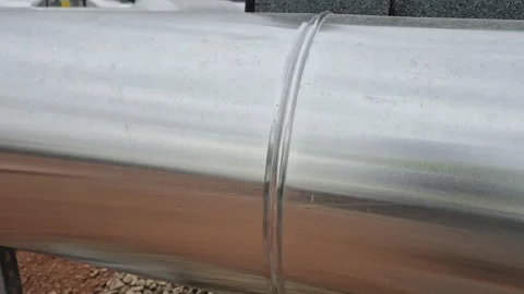Horizontal tracking shot of ventilation air duct on a rooftop Stock Footage 334802870