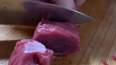 Horizontal video close up. Man cutting piece of beef meat with knife 스톡 동영상 304766577