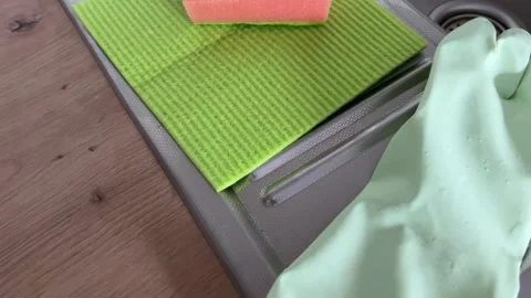 Horizontal video of kitchen cleaning supplies on the edge of a metal sink Stock Footage 308930110
