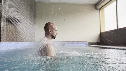 Horizontal video man in spa giving himself a massage with water jets Stock Footage 292058574