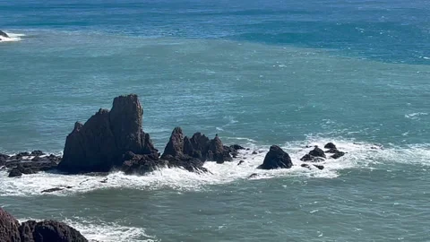 Horizontal video of waves breaking over rocks on the coast Stock Footage 266063460