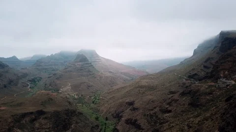 Horizontal view of gloomy mountain peaks hiding in clouds. Flying over mountains Stock Footage 94120286