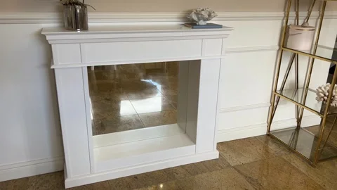 Horizontal view of handcrafted white wooden fireplace mantle with mirror 스톡 동영상 342954031