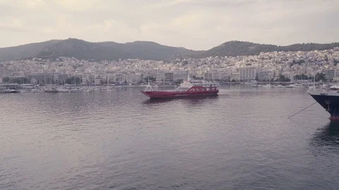 Horizontal view of Kavala docks in Greece. Red yacht staying still in calm Stock Footage 115721263