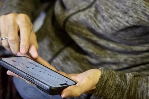 Horizontal view of man using smartphone indoors Stock Photos