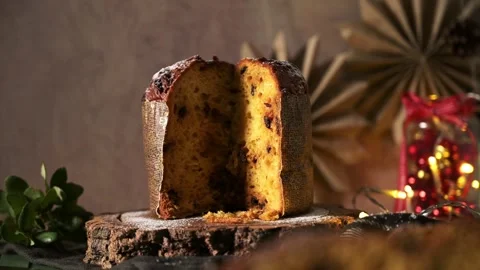 Horizontal View of Sliced Panettone on Rustic Wood with Warm Christmas Lights Video stock 321040808
