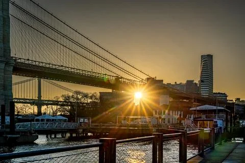 Horizontal view of the sun rising over DUMBO section of Brooklyn Stock Photos