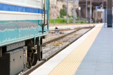 Horizontal View of a Train Stopped in a Railway Station on Blur Background Stock Photos