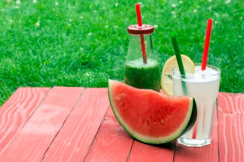 Horizontal view of a watermelon and two drinks Stock Photos