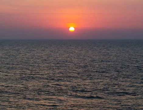 Horizontal vivid vibrant dramatic sunset in Indian ocean backgro Stock Photos