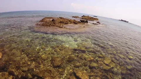 Horizontal wide angle view at rocky shore look out to horizon Xianglu and Peaked Stock Footage 242997200