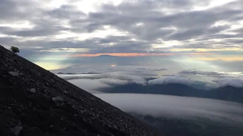 Horizontal Wide Shot of Mount Rinjani Sunrise Above Clouds 動画素材 338340900