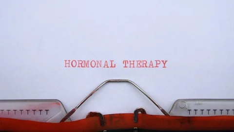 Hormonal therapy - phrase printed on an old typewriter in red letters, close up. Stock Footage 128399514
