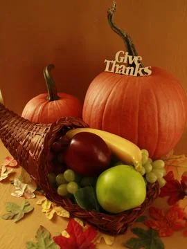 Horn of plenty filled with fruit (cornucopia) and assorted pumpkins Stock Photos