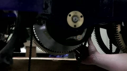 Horologist Inspecting Large Clockwork Gear Mechanism Stock Footage 345753108