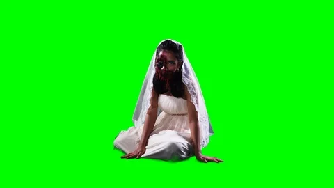 Horrible zombie looking at camera while sitting Stockbeeldmateriaal 115501346