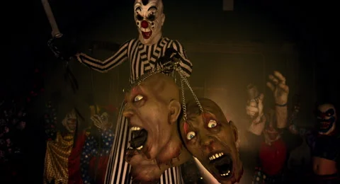 Horror clowns. The clown on stilts holding a chain with decapitated. Stock Footage