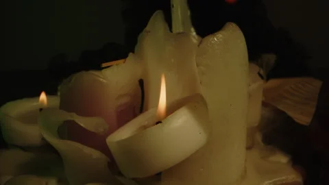 Horror concept: Dolly of burning candles and a blood filled glass skull on an Stock Footage 335265807